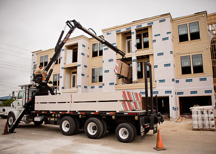 Drywall Truck Unloading at Commercial Job Site