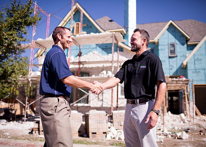 Sales Rep Shaking Hands with Residential Builder